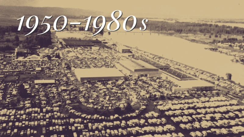 This sepia-toned aerial photograph, dating to the 1950s, captures three architecturally related buildings amid expansive parking lots densely packed with mid-century automobiles, offering a vivid snapshot of postwar development and car-centric infrastructure.