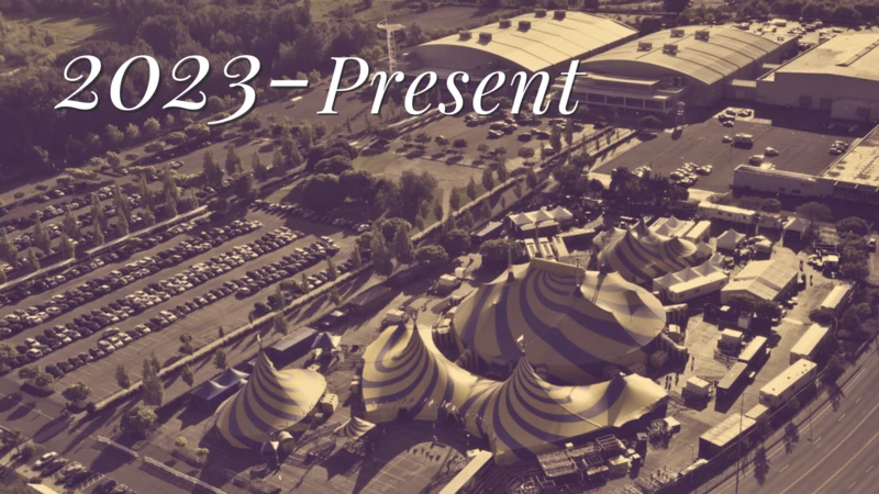 A sepia-toned aerial view of the Portland Expo Center with swirly-patterned Cirque du Soleil tents in the parking lot.