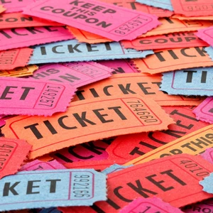 A stack of paper tickets in different colors: blue, red, orange