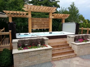 Outdoor hot tub with deck built around it.