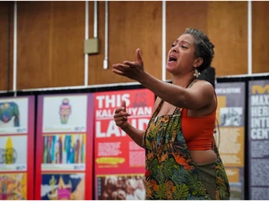 a photo of a women singing at the vanport mosaic festival
