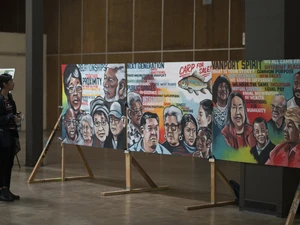 an image of a person looking at art displayed at vanport mosaic festival