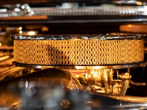 A photo from the Lowrider Experience showing a clean, gold engine