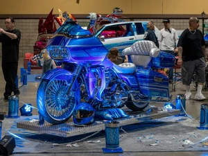 A photo from the Lowrider Experience showing a blue and purple motorcycle