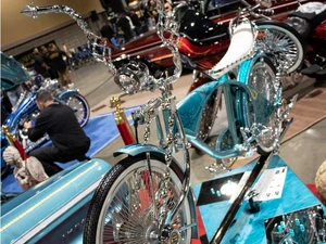 A photo from the Lowrider Experience showing a light blue bike with chrome details