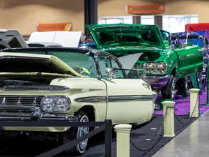 A photo from the Lowrider Experience showing a with multiple lowrider cars lined up in a row