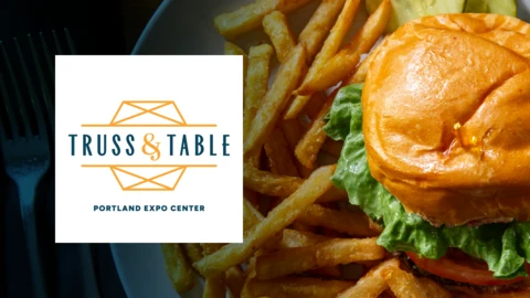 A detailed image of a burger and fries next to a logo for Truss & Table.